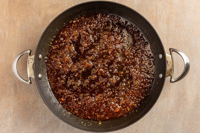 making sauce in a skillet for Pineapple Pork Chops