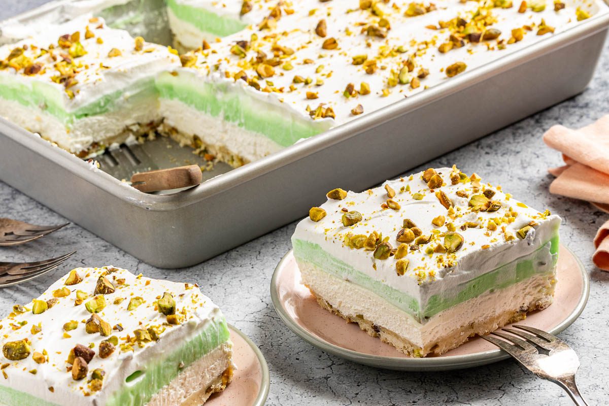 Taste of Home Pistachio Pudding Dessert photo of the finished recipe cut into slices and served on plates.