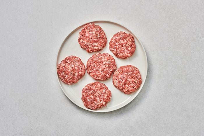 Meat mixture shaped into 6 patties on a plate