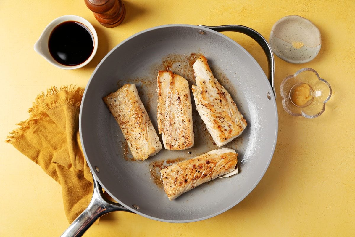 Process of making Taste of Home's Teriyaki Mahi Mahi laid out in small bowls on bright yellow surface.