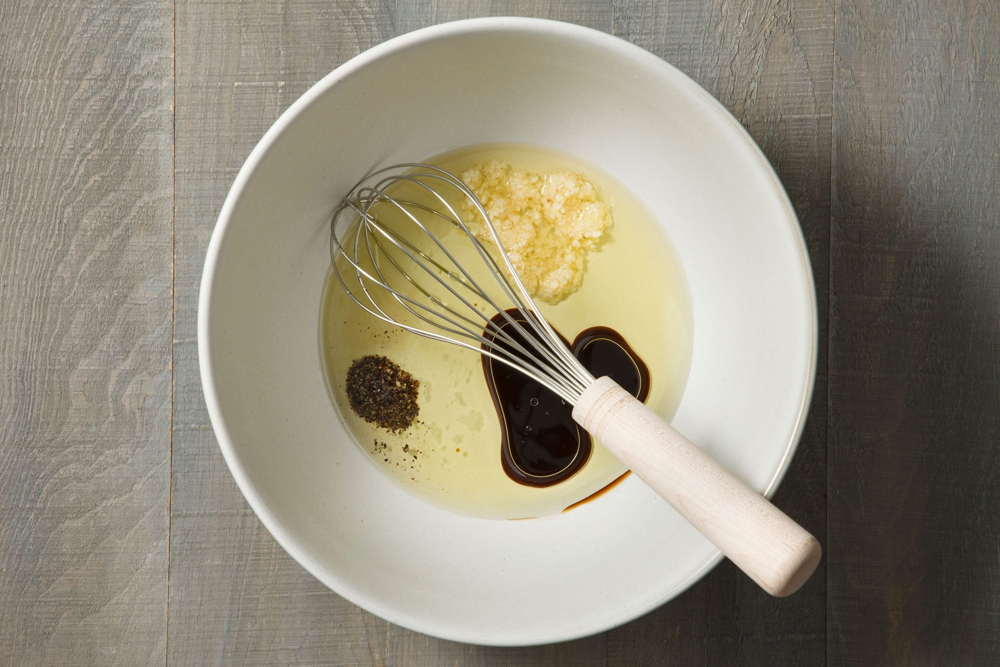 In a large bowl, combine olive oil, Worcestershire, garlic, salt and pepper.