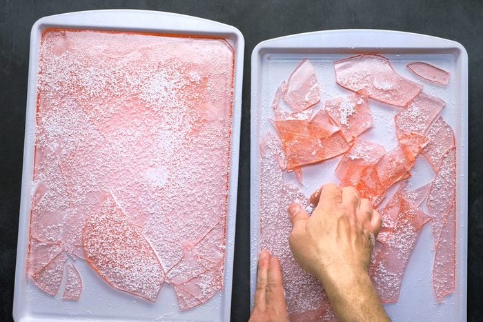 breaking cooled candy into pieces