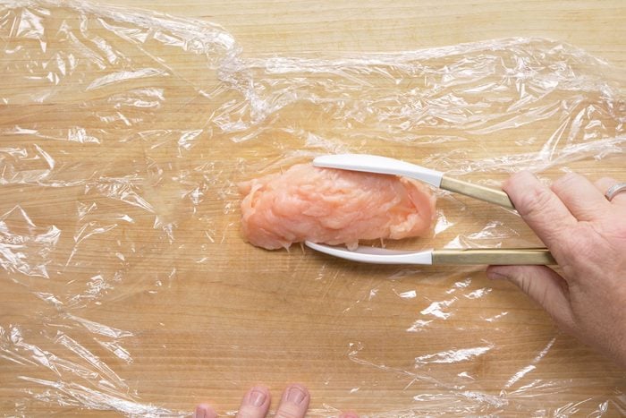 Securing chicken breast roll by inserting toothpicks
