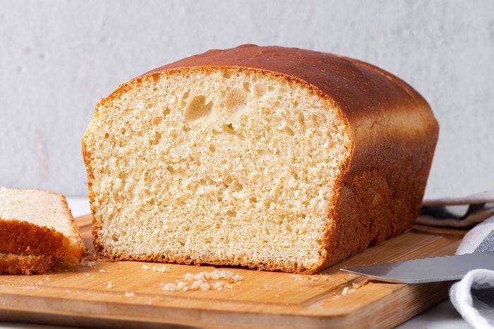 Sliced Country White Bread on a wooden cutting board for Taste of Home