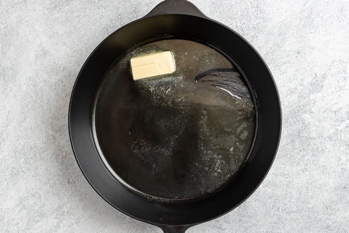 Taste of Home Grilled Catfish photo of melting the butter in a cast iron skillet.