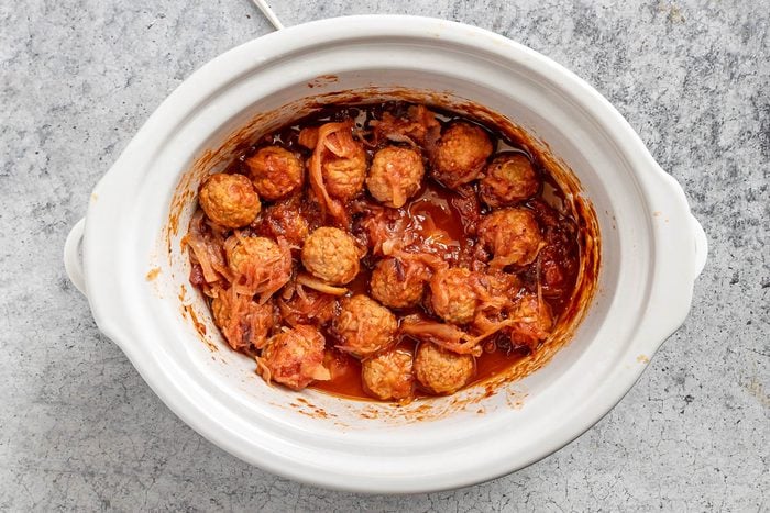 Taste of Home Sauerkraut Meatballs photo of the cooked meatballs in the slow cooker.