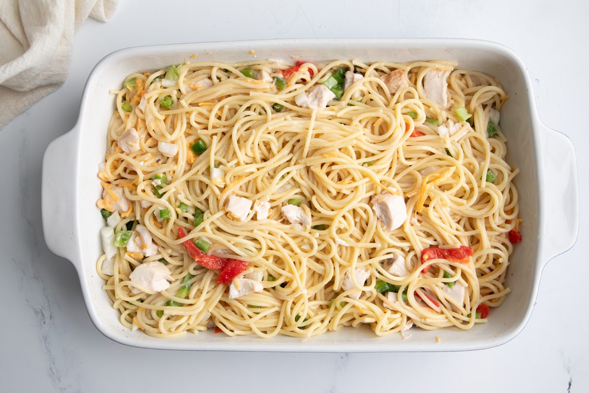 Overhead shot for Taste of Home Turkey Tetrazzini with Cream of Mushroom Soup, ingredients in a large baking dish.