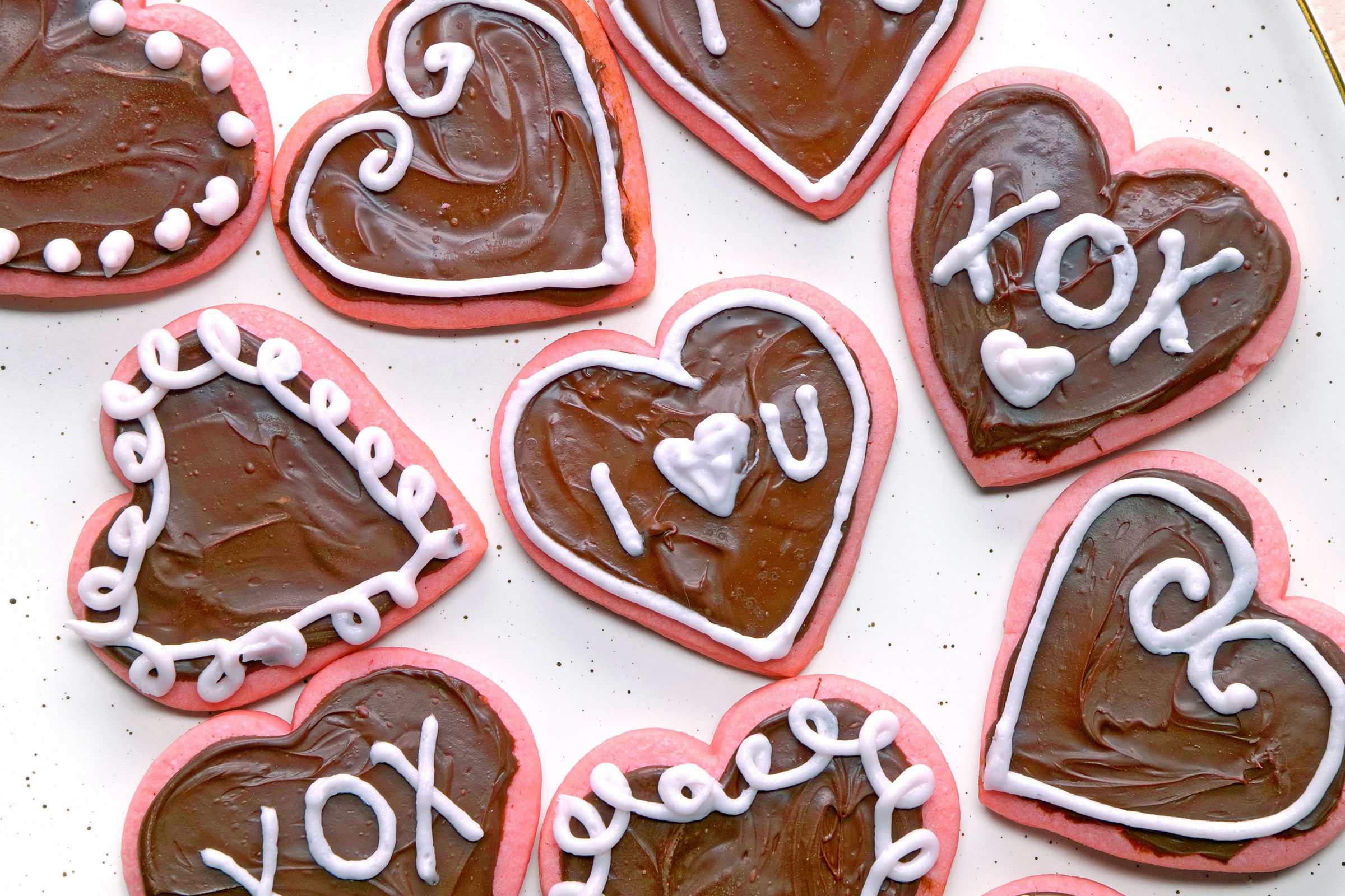 Top view of Valentines Cookies decorated with chocolate glaze and frosting