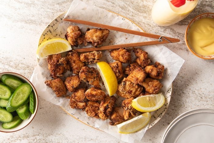 Japanese Fried Chicken (chicken Karaage) with lemon and cucumber on side