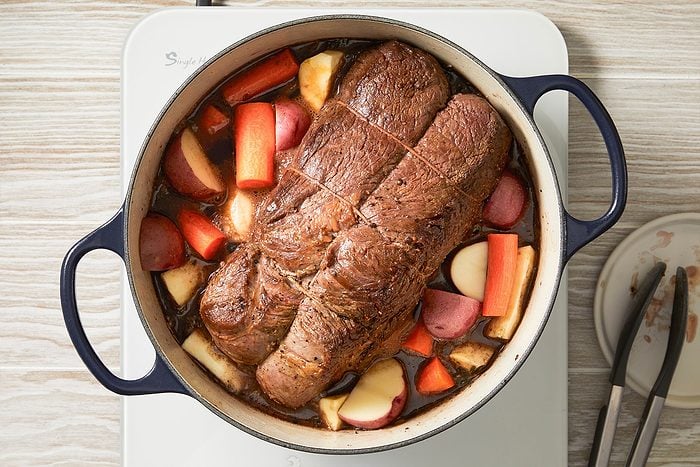 Cooked roast in a pan with vegetables