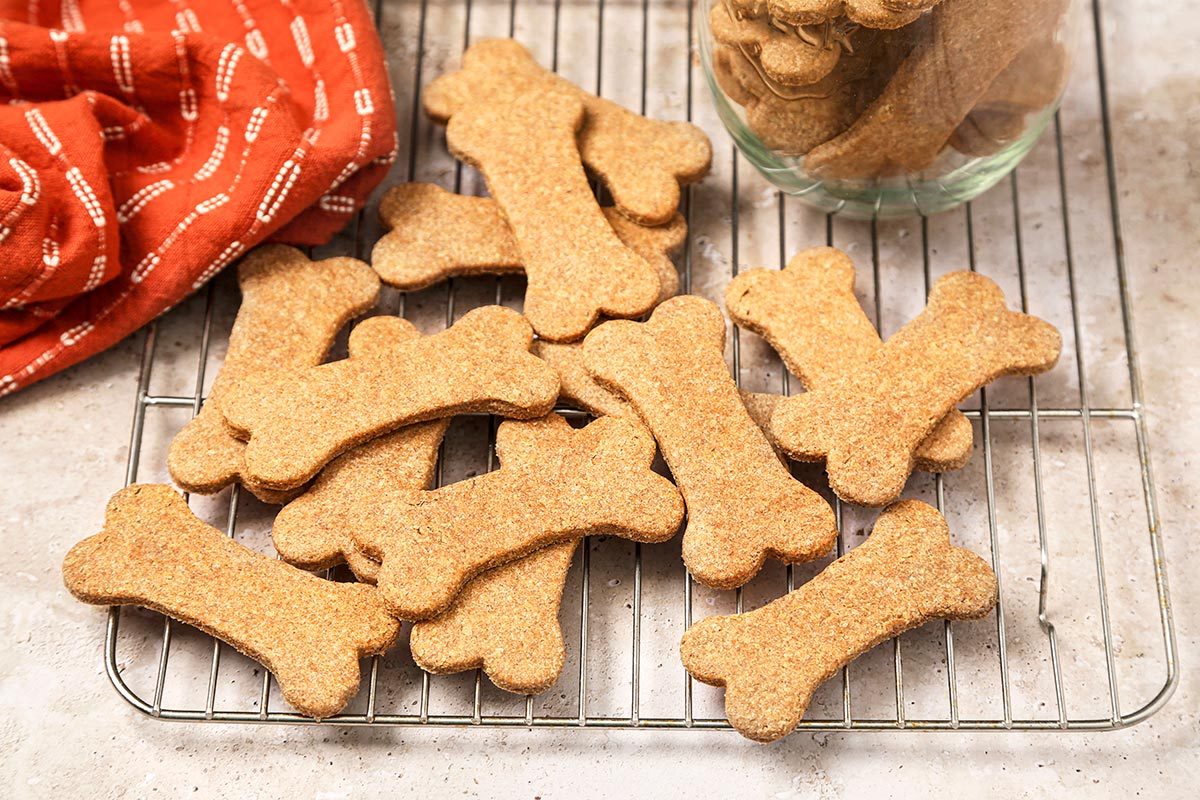 Homemade peanut butter dog treats cooling on a wire rack.