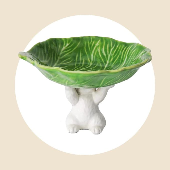White bunny holding a cabbage dessert tray on a white and tan background