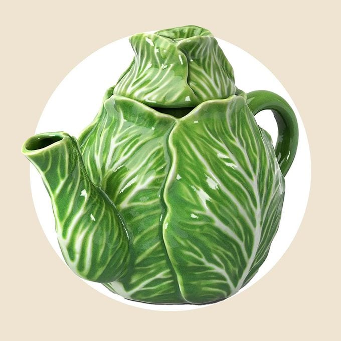Cabbage tea pot on a white and tan background