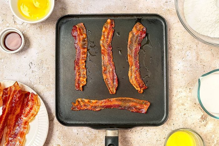 Bacon cooked in a large griddle pan