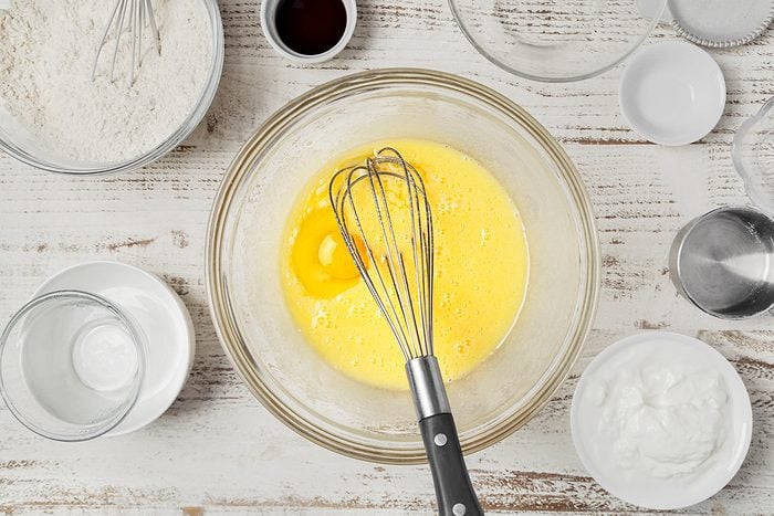 sugar, oil and eggs mixed together in a bowl