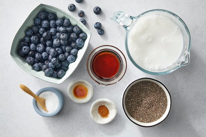 A top view of various ingredients on a light surface.