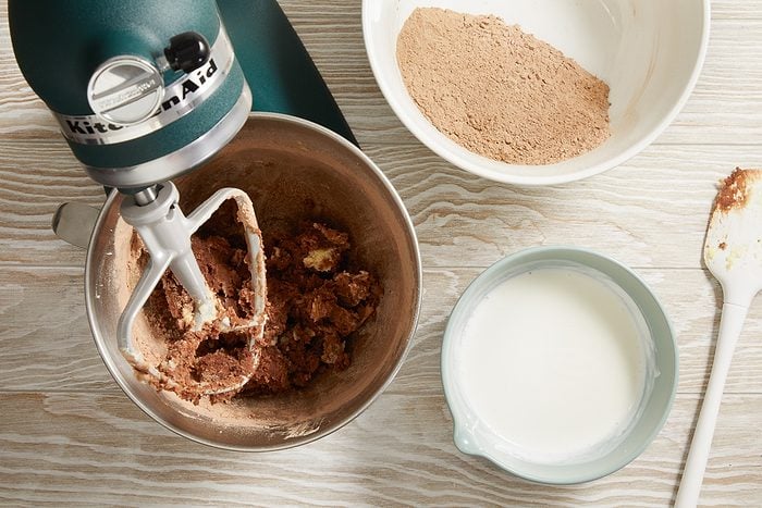 dry ingredients being mixed in with creamed mixture