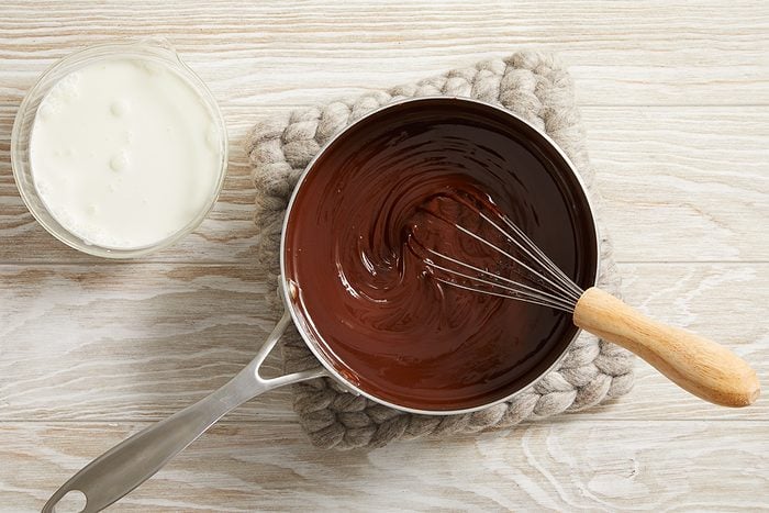 melted butter and chocolate being mixed in a saucepan