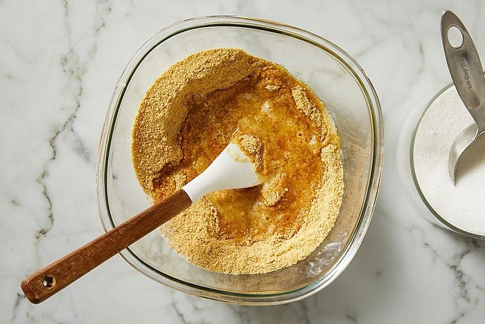 In a bowl, combine the graham cracker crumbs, butter and sugar.