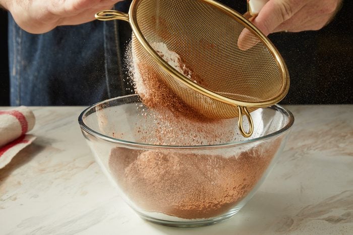 sifting the flour, cocoa, baking powder, baking soda and salt in a small bowl
