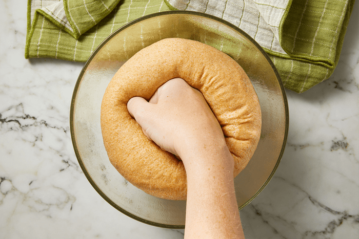 Punching the dough to remove air bubbles