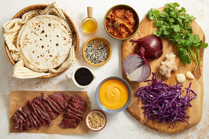 soy sauce, brown sugar, sesame oil, ginger root, garlic cloves, sirloin steak, cabbage, cilantro, mayonnaise, tortillas and toppings