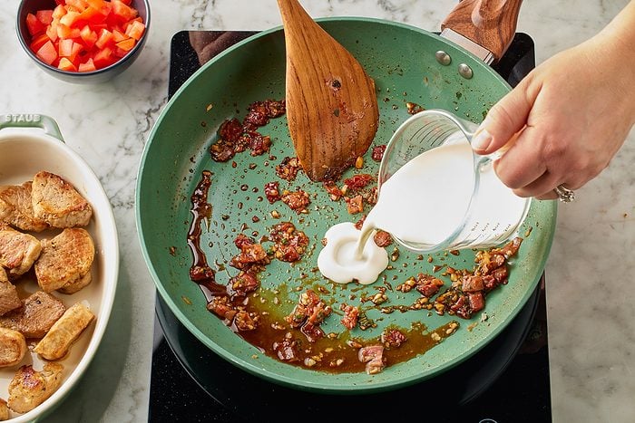 heavy cream being added to pan