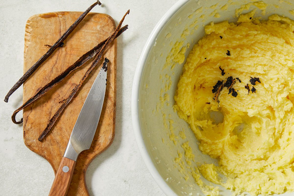 Overhead image of vanilla bean seeds scraped into the creamed butter mixture, infusing the cupcake batter with rich, aromatic vanilla flavor.