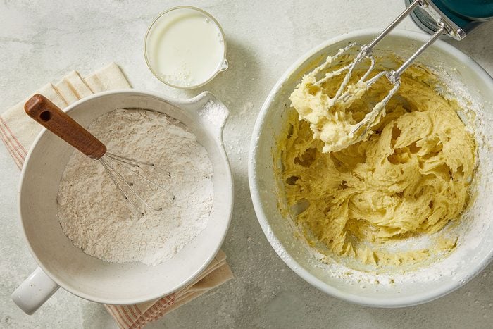 Overhead view of cake flour, baking powder and salt whisked together before being added to the batter. The dry ingredients ensure light, tender cupcakes.