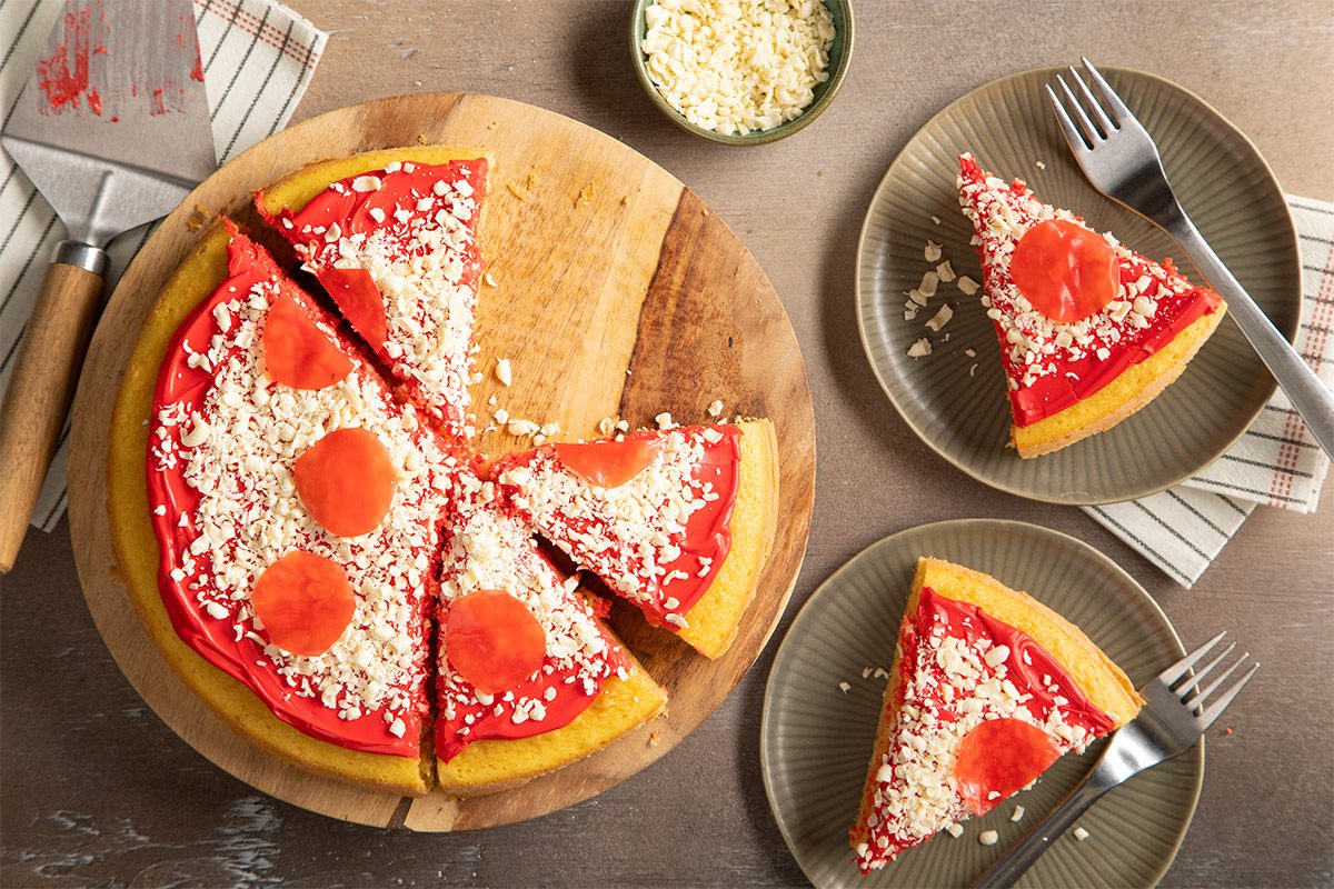 Overhead shot of prepared pizza cake slices served on a plate with the main cake next to it.