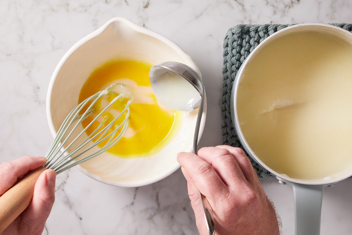 whisking cornstarch mixture into egg yolks