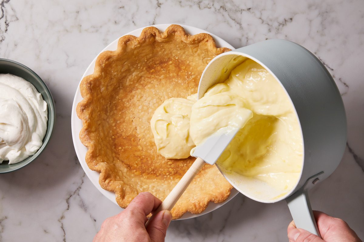 pie filling being added to cooled crust