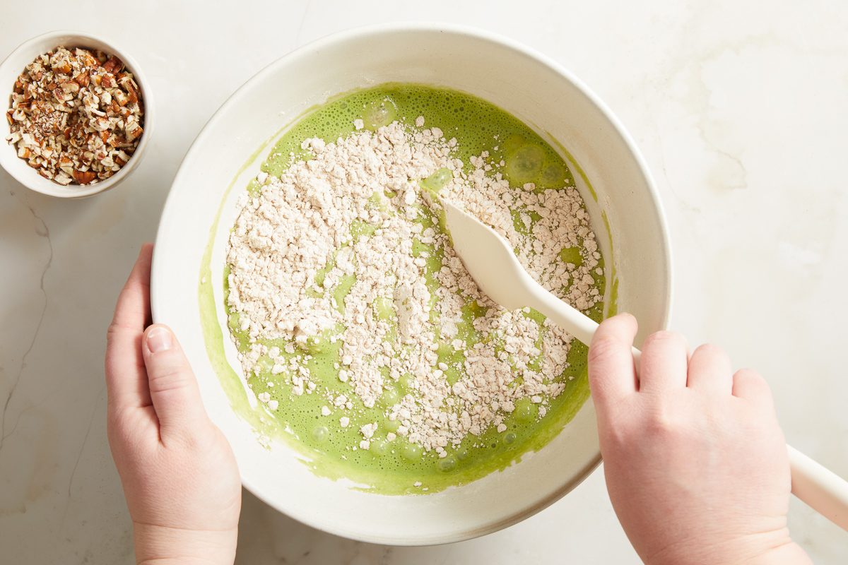 spinach mixture being mixed with dry ingredients