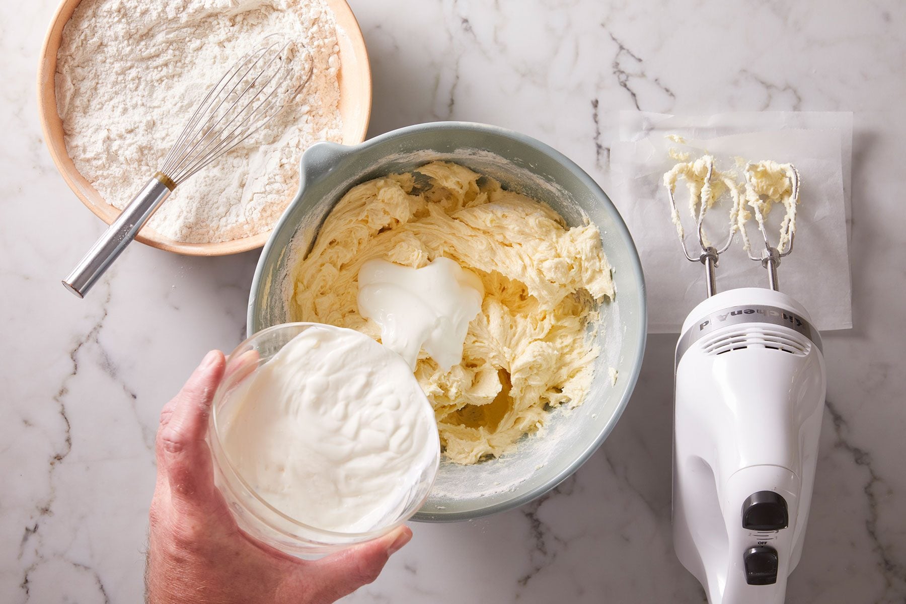 Adding sour cream and dry ingredients into butter and sugar mixture.