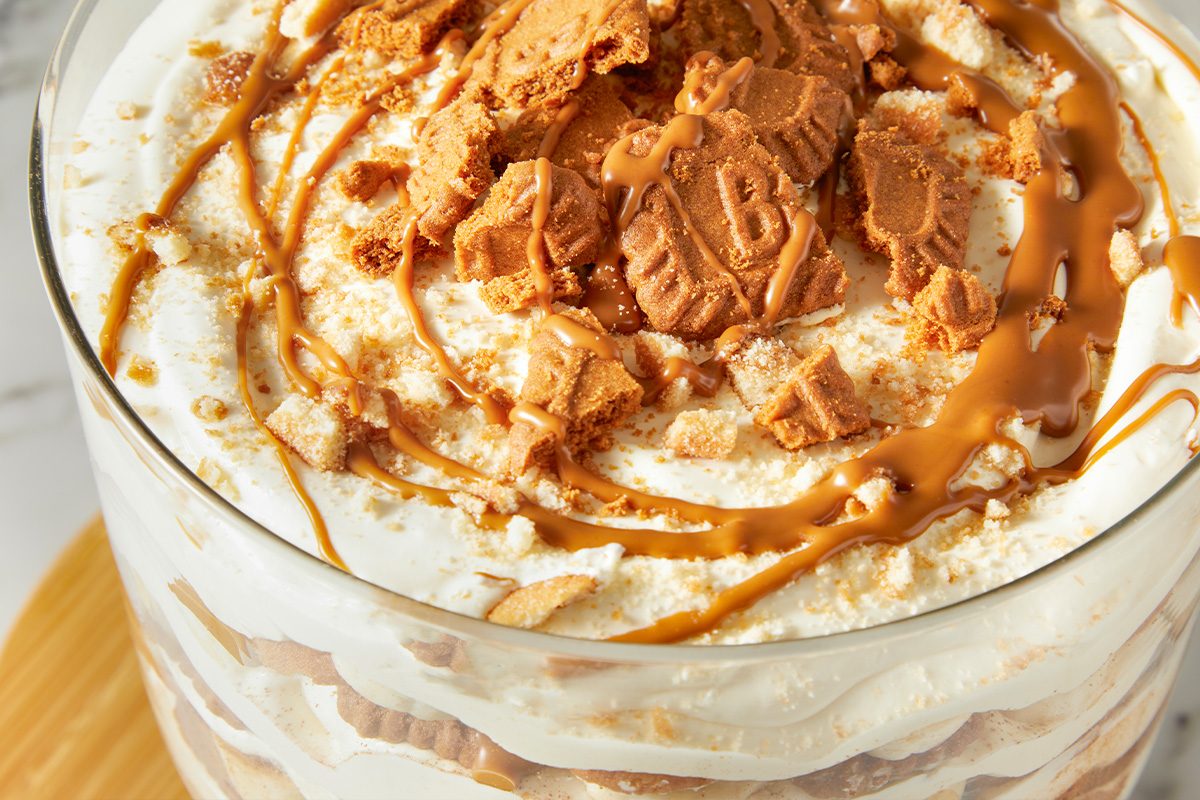 Eye-level horizontal close-up of Biscoff banana pudding showing cookie topping and creamy texture.