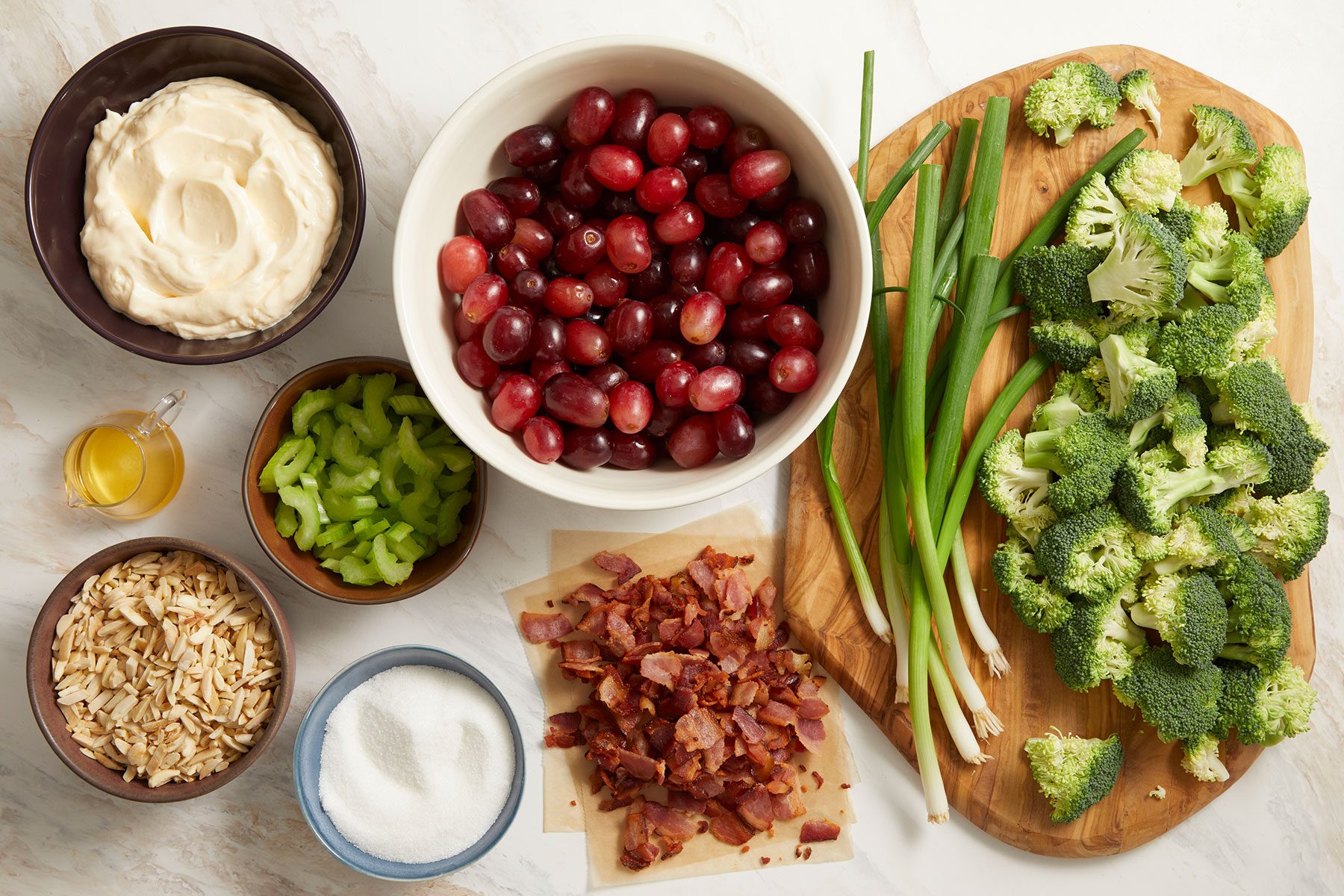 Ingredients for Broccoli Grape Salad on a kitchen counter.