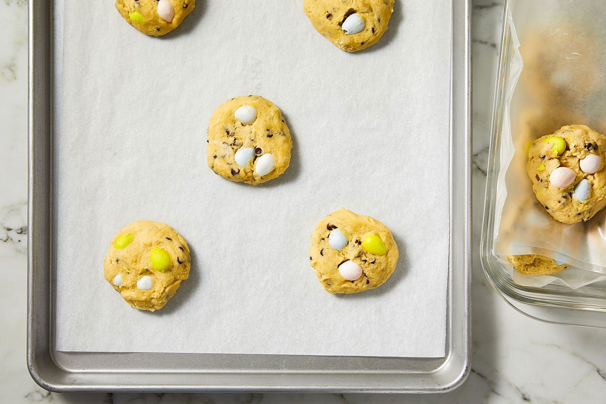 Overhead horizontal image of cookie dough balls spaced on a baking sheet ready for baking.