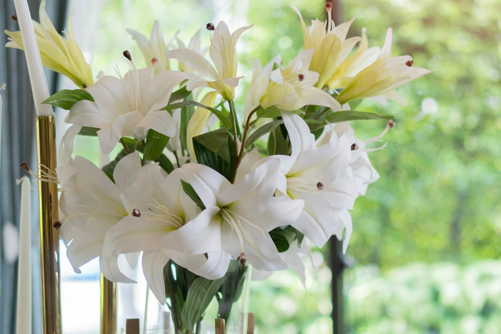 Flower decorations on the banquet table, prepared for event party or wedding on nature background.