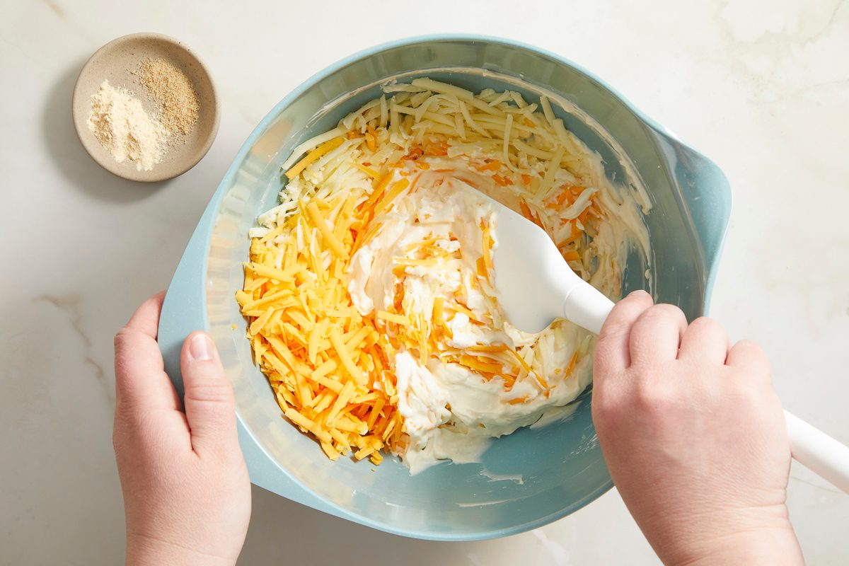 blending cream cheese and mayonnaise in a large bowl