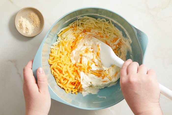 blending cream cheese and mayonnaise in a large bowl