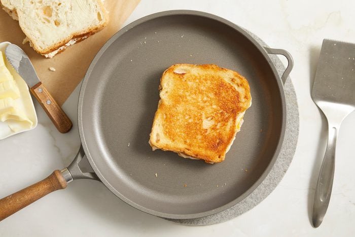 sandwich being toasted in a skillet