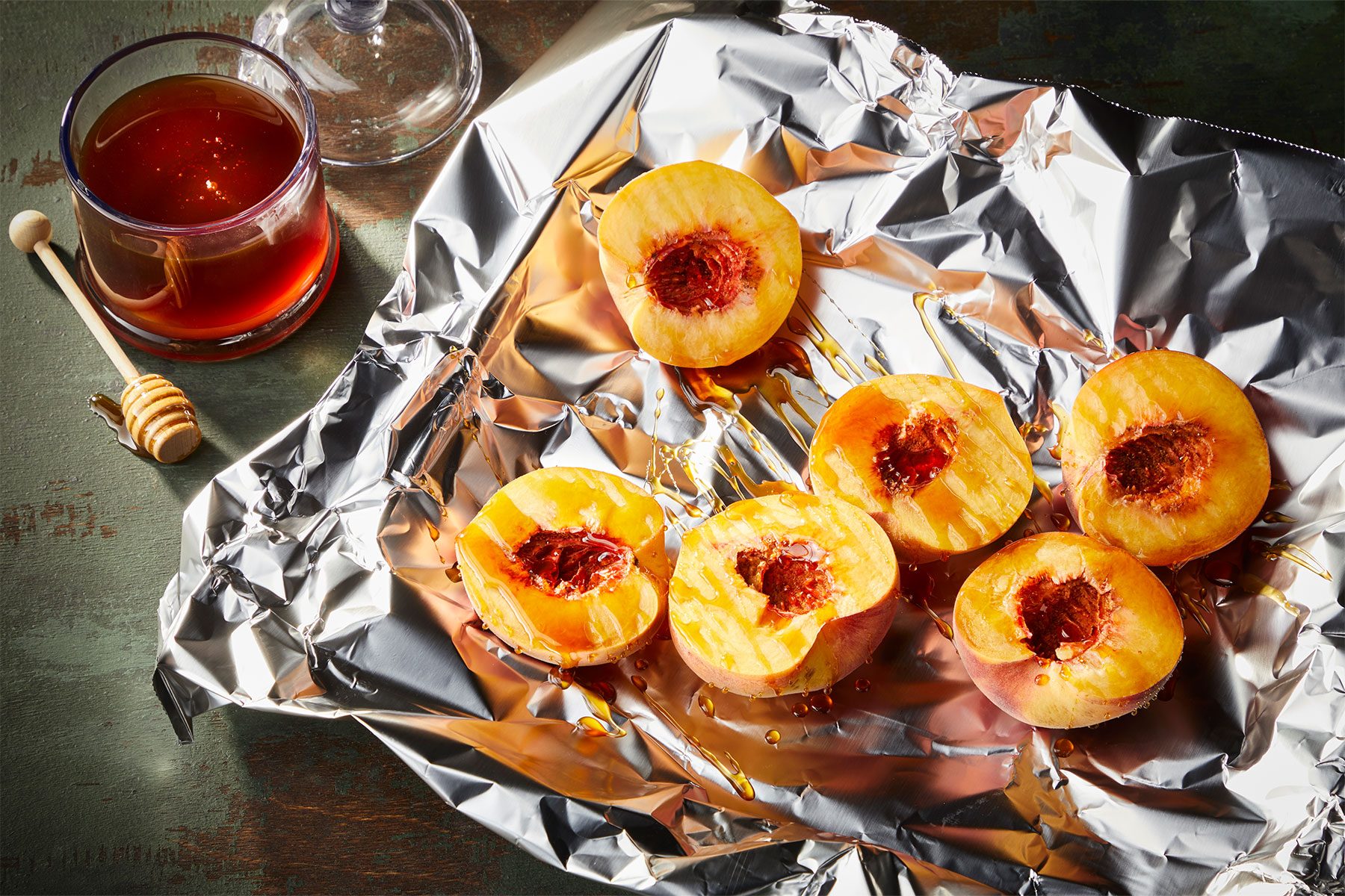 peach halves, cut sides up, on the foil and drizzled with the hot honey