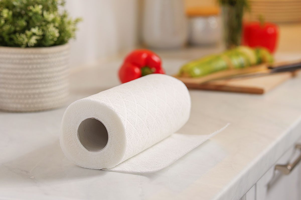 Roll of paper towels on white marble countertop in kitchen