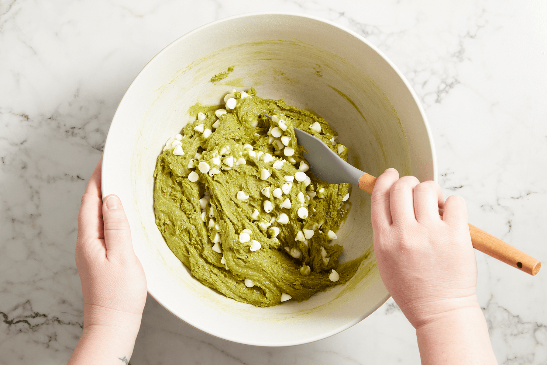 Fold in white chocolate chips in butter batter to make macha brownies