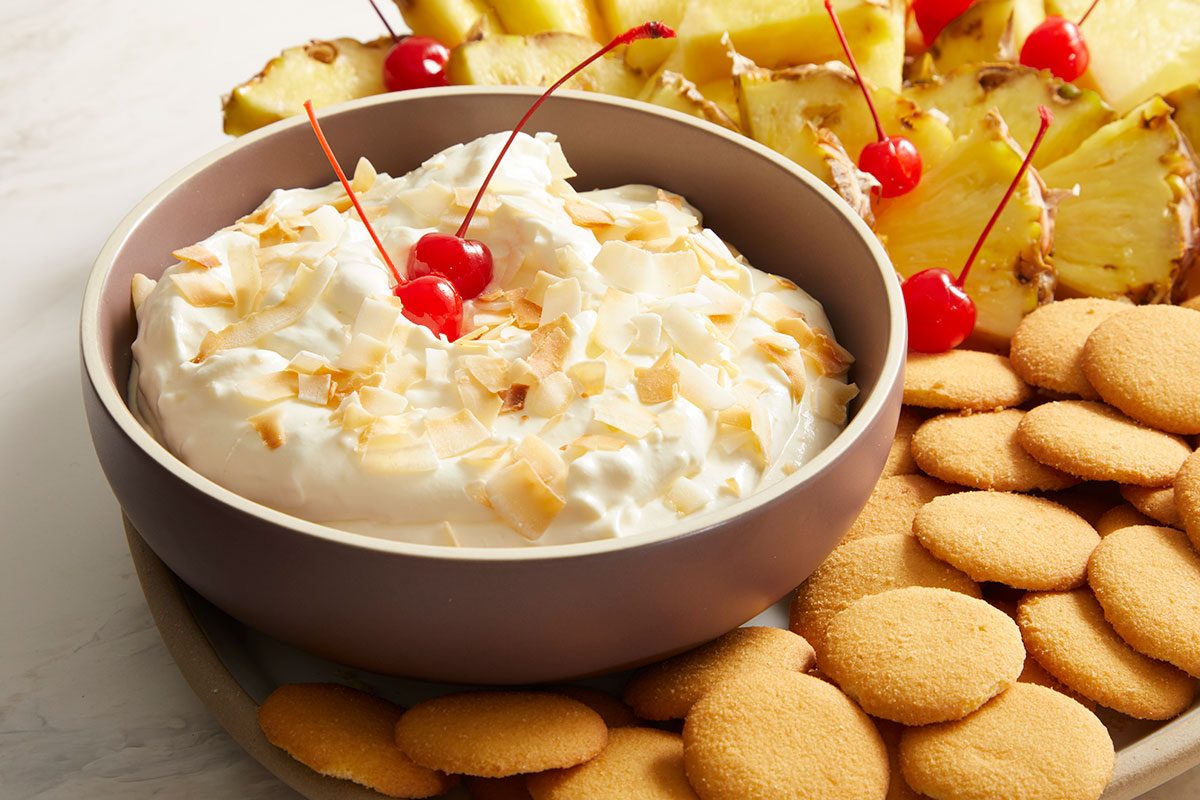 3/4 shot of a serving platter with a bowl of creamy Pina Colada Dip