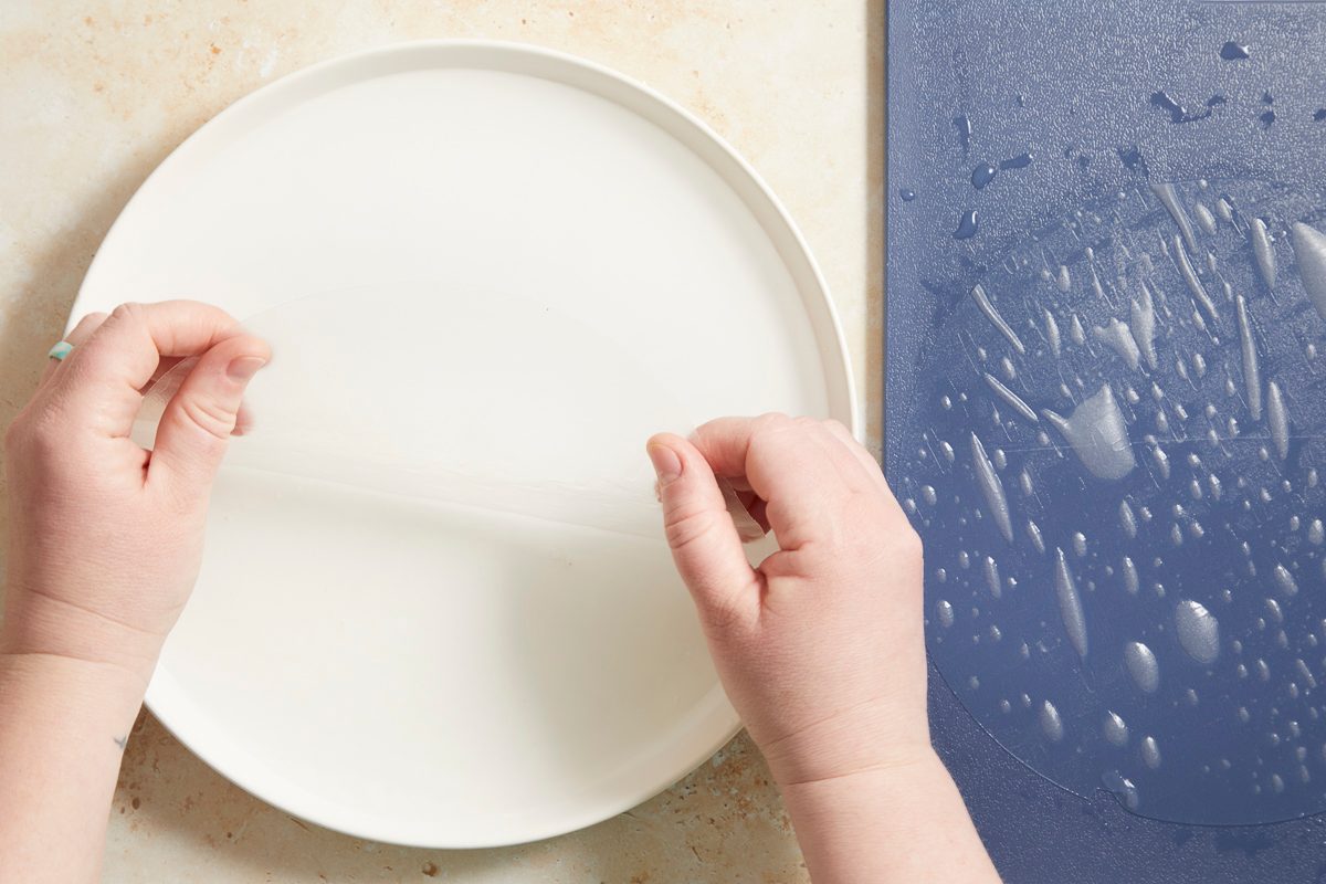 lifting softened rice paper from water in shallow dish