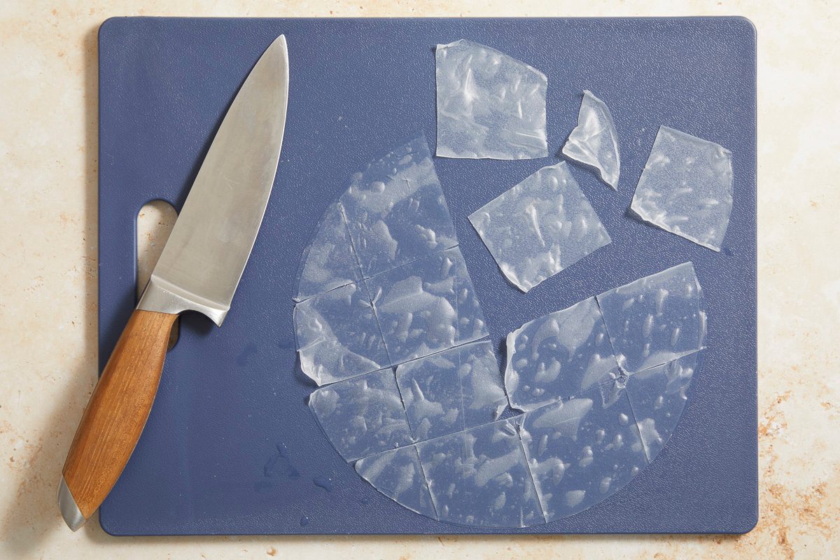 rice paper on a cutting board cut into 2 inch squares