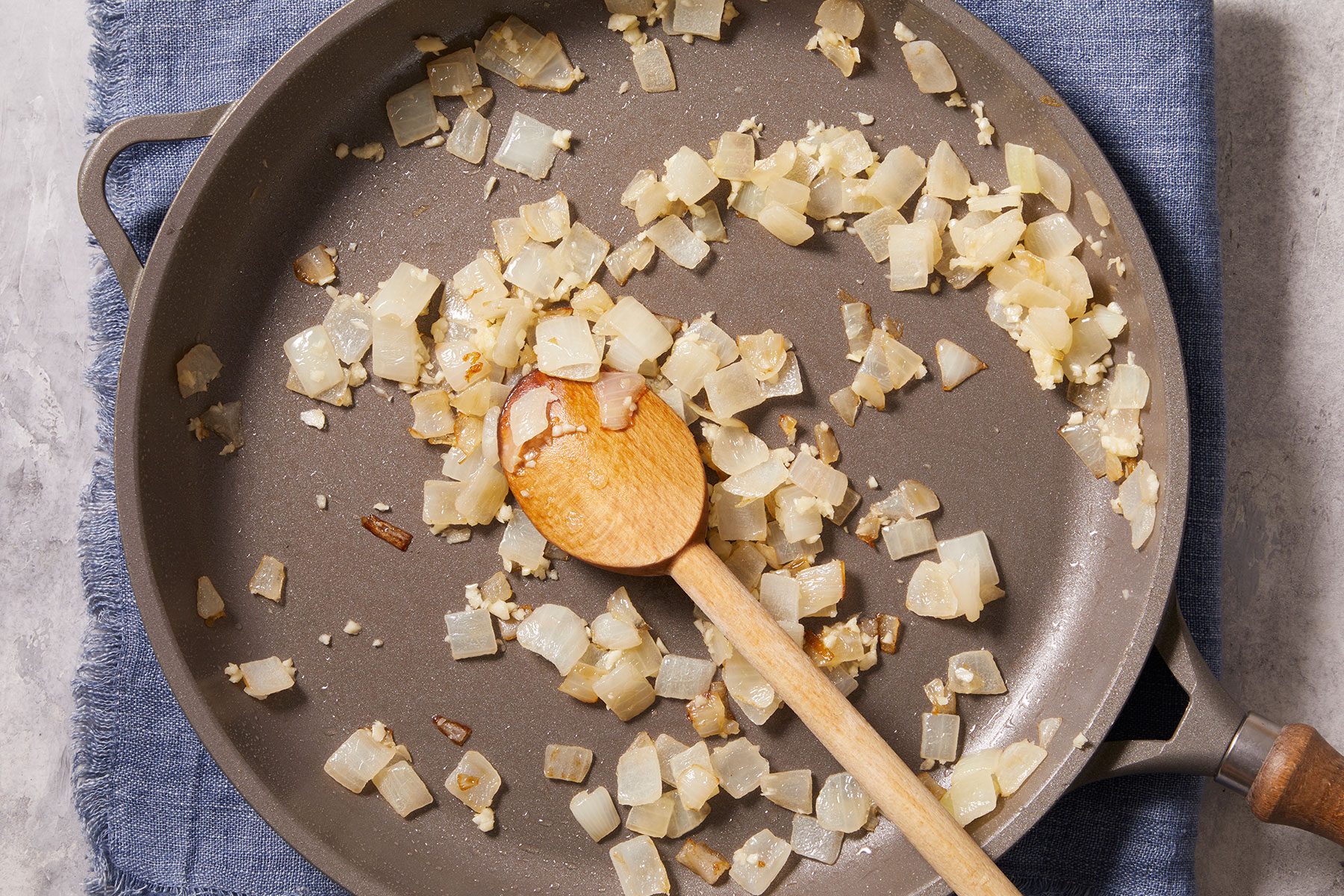 Cooking diced onions and minced garlic in oil in a medium skillet.