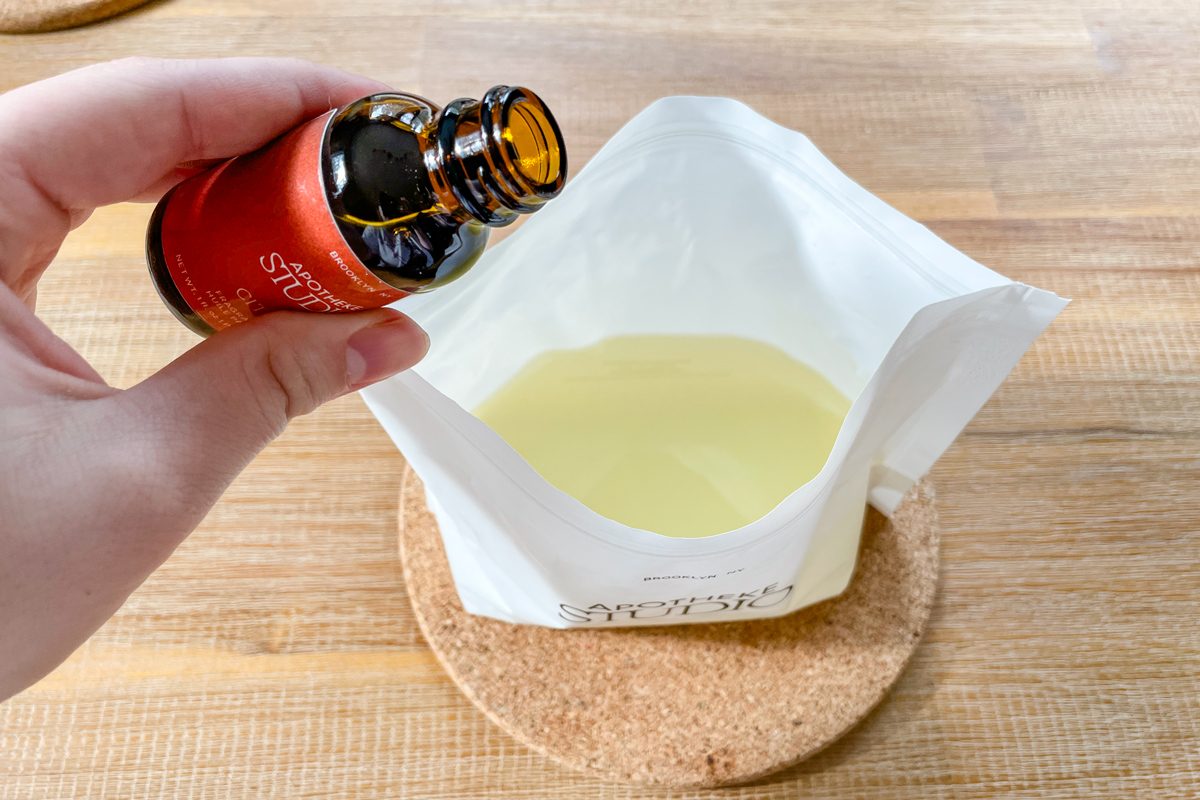 adding fragrance to melted wax in bag