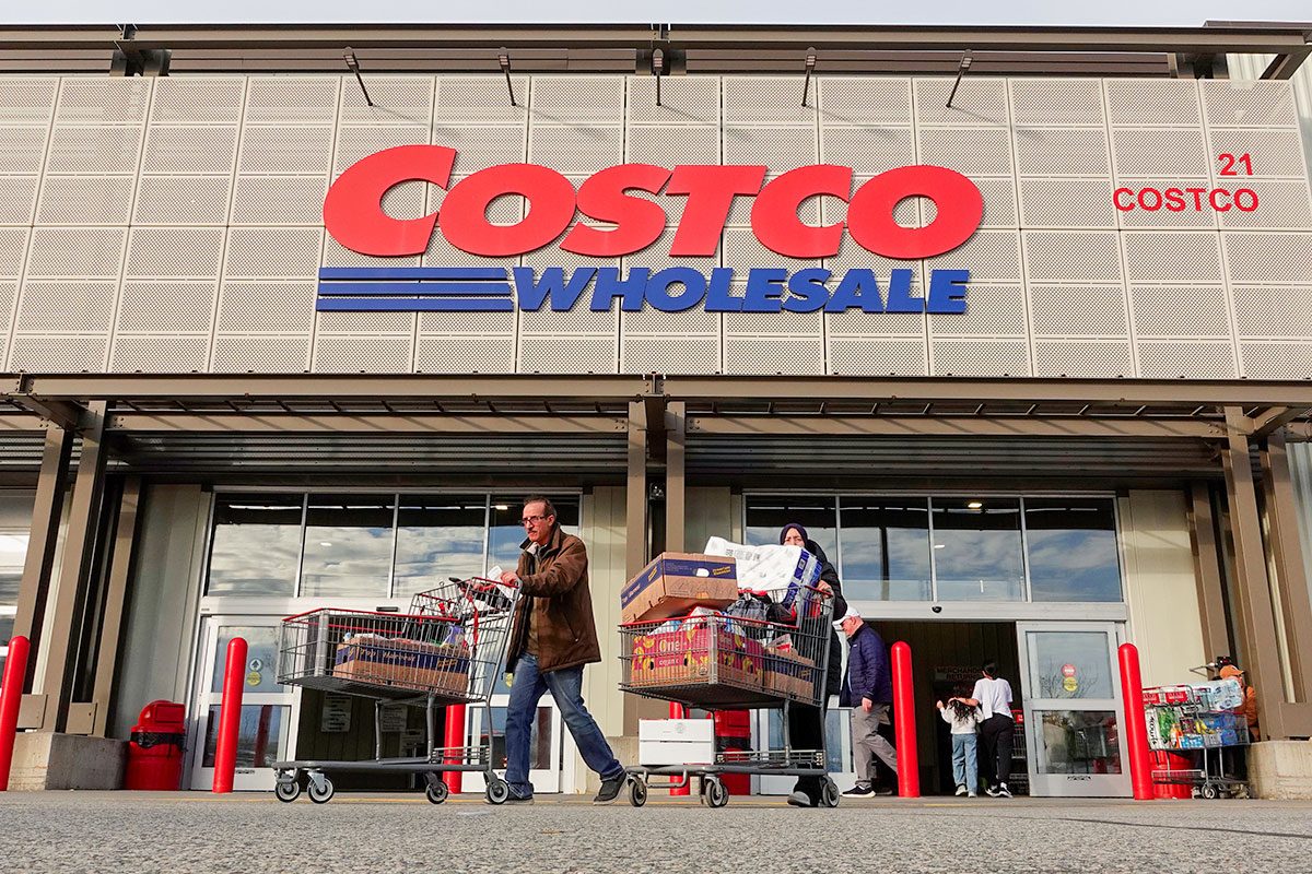 People leave a Costco Wholesale store after shopping